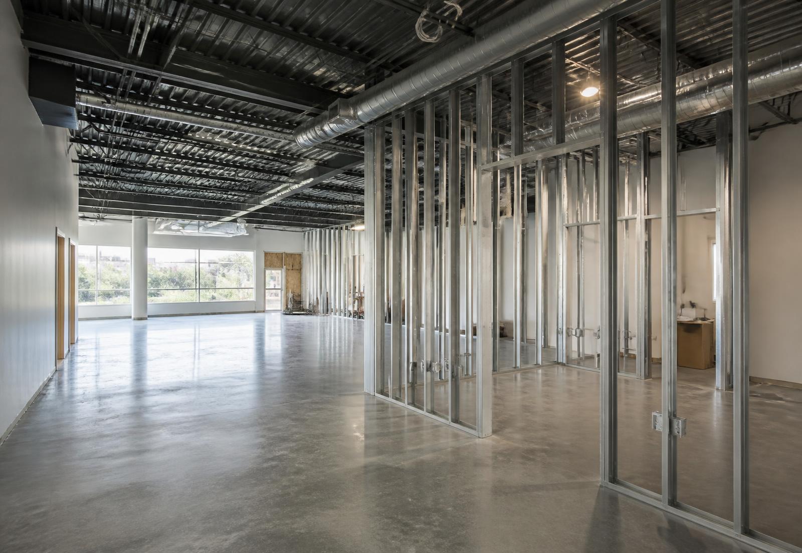 Commercial interior during a tenant build-out with new framing and exposed structure
